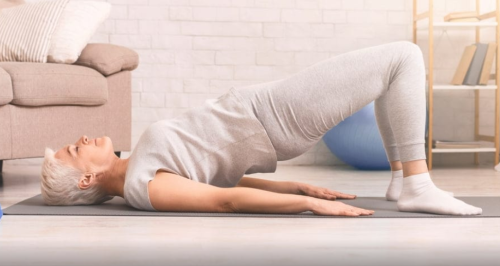 Woman performing a glute bridge exercise
